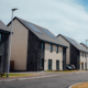 Semi-detached and terraced new build housing with blockwork and render facade, Ballindean Road, Dundee