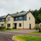 Detached new build homes with render and dark cladding, Douglas Place, Dunblane