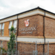 Oakbank Care Home Crieff exterior signage with red squirrel logo on brick corner elevation