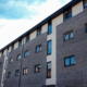 Block of flats with charcoal brick and cream feature panels, Raglan Street, Dundee